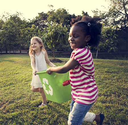 Girls playing with recycling bin